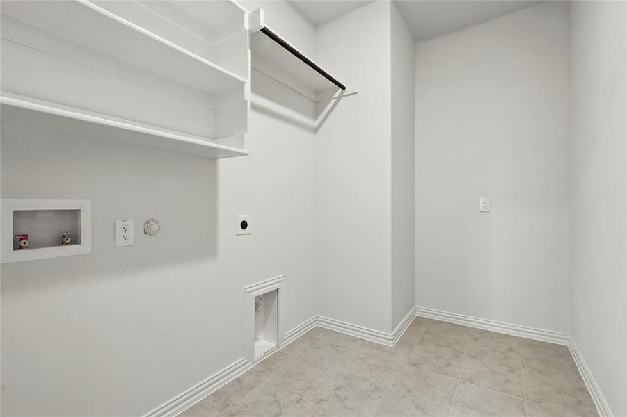 Laundry room featuring gas dryer hookup, electric dryer hookup, washer hookup, and baseboards Laundry room featuring gas dryer hookup, electric dryer hookup, washer hookup, and baseboards
