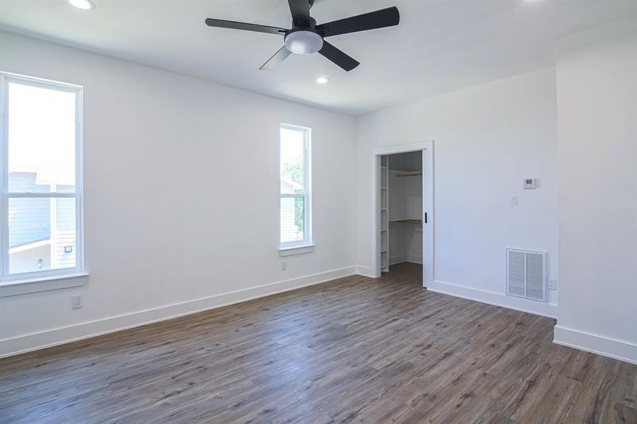 Spare room featuring ceiling fan and dark wood-type flooring