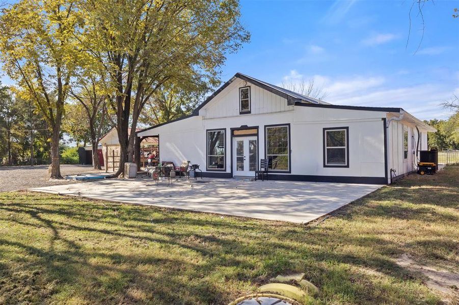 Rear view of property with french doors, a yard, and a patio Rear view of property with french doors, a yard, and a patio