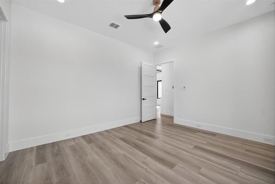 Spare room with light wood finished floors, recessed lighting, and a ceiling fan