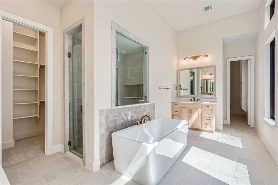 Bathroom with vanity, plus walk in shower, and tile patterned flooring