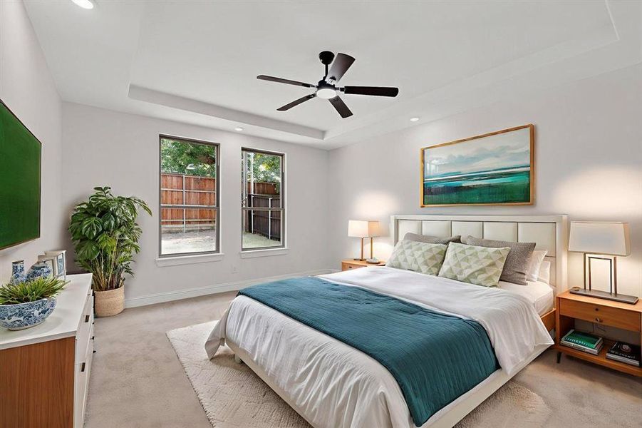 Bedroom featuring a tray ceiling, carpet floors, a ceiling fan, and recessed lighting Bedroom featuring a tray ceiling, carpet floors, a ceiling fan, and recessed lighting