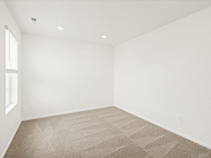 Spacious, unfurnished interior of a new home in Ridgeline Vista: The Flora Collection, Brighton (Image 25).