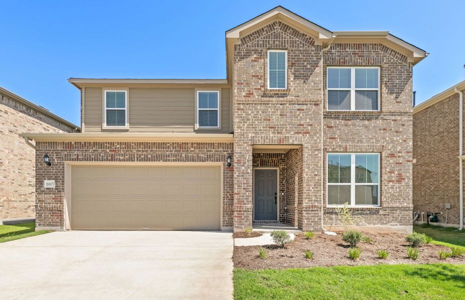 Front exterior of a new home in Lagos, Manor, TX, highlighting curb appeal (Image 19). Front exterior of a new home in Lagos, Manor, TX, highlighting curb appeal (Image 19).