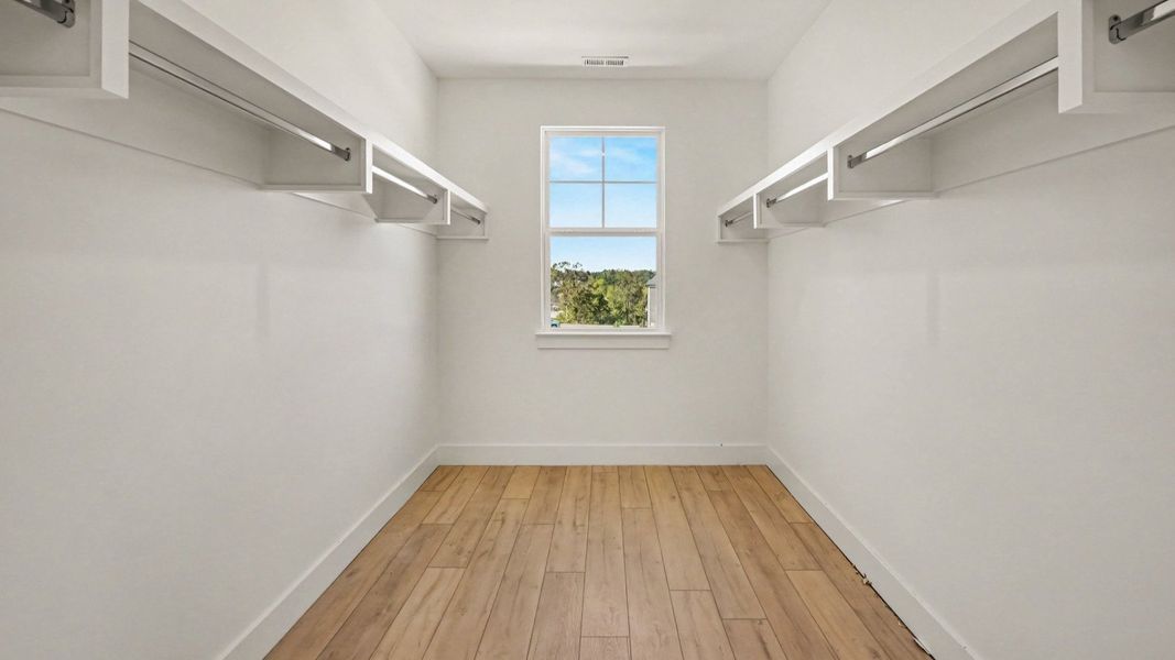 Elevated primary bedroom walk-in closet in the Solace II plan Elevated primary bedroom walk-in closet in the Solace II plan