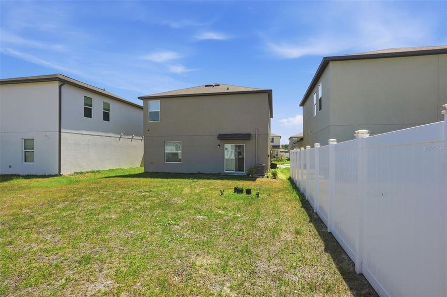 Exterior details and patio area of a home in The Isle of Avalon, Spring Hill (Image 4).