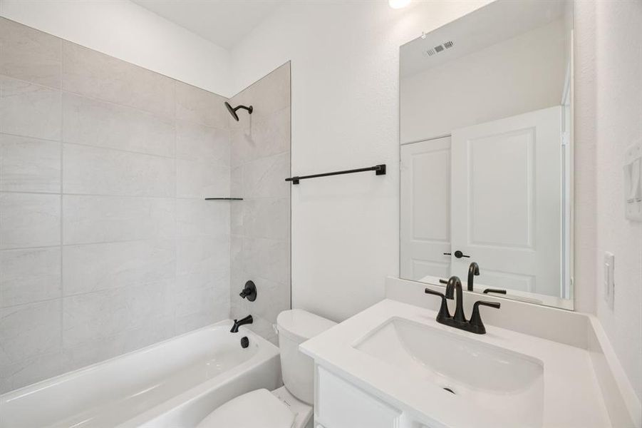 Bathroom featuring vanity and shower / bath combination Bathroom featuring vanity and shower / bath combination