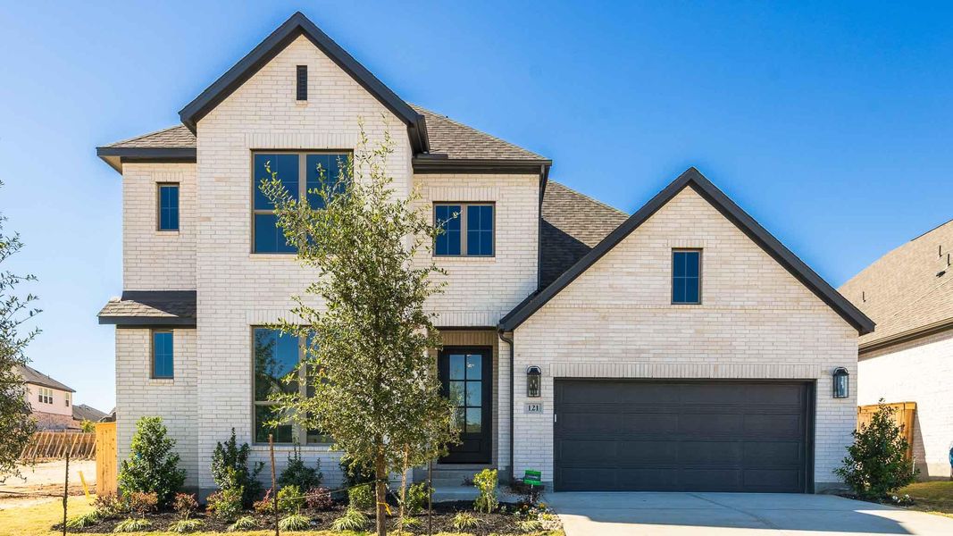 Front exterior of a new home in Nolina 60', Georgetown, TX, highlighting curb appeal (Image 1).