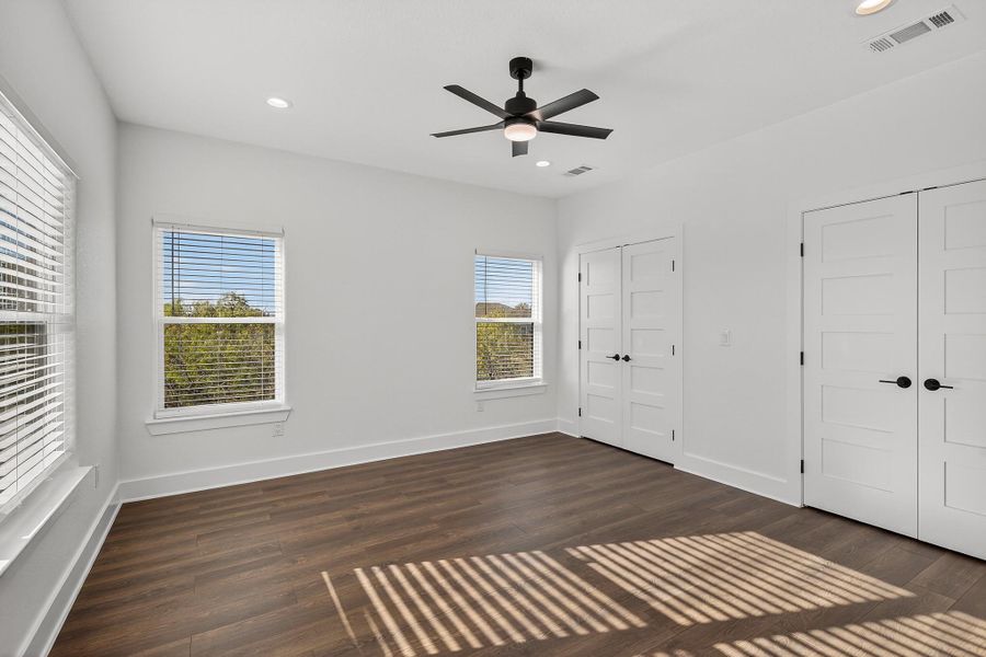 Unfurnished bedroom featuring two closets, dark wood-style floors, recessed lighting, and ceiling fan Unfurnished bedroom featuring two closets, dark wood-style floors, recessed lighting, and ceiling fan