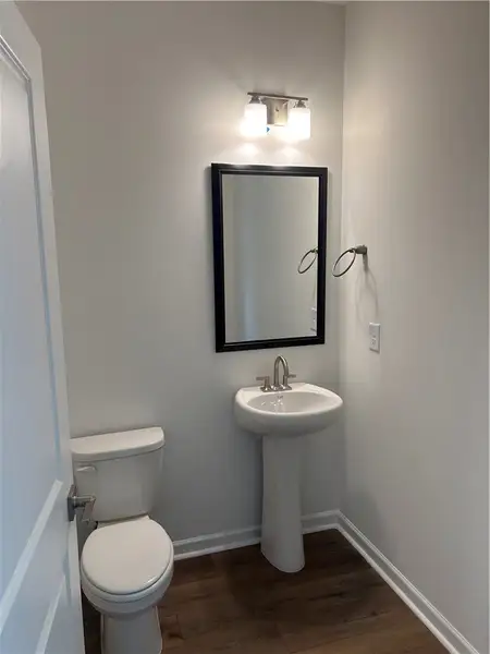 A well-appointed lavatory with a pedestal sink and