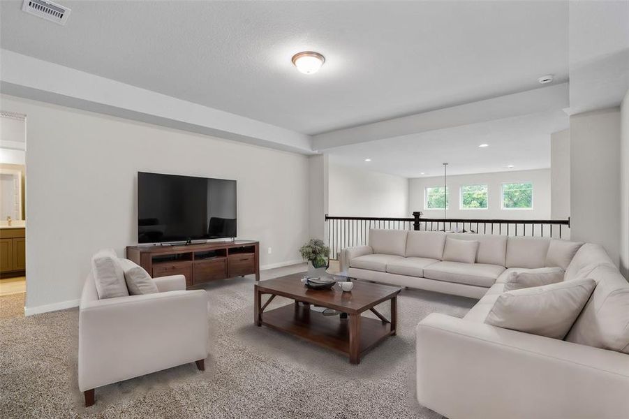 Come upstairs and enjoy a day of leisure in this fabulous game room! This is the perfect hangout spot or adult game room, this space features plush carpet, high ceiling, recessed lighting, custom paint and open to the downstairs.