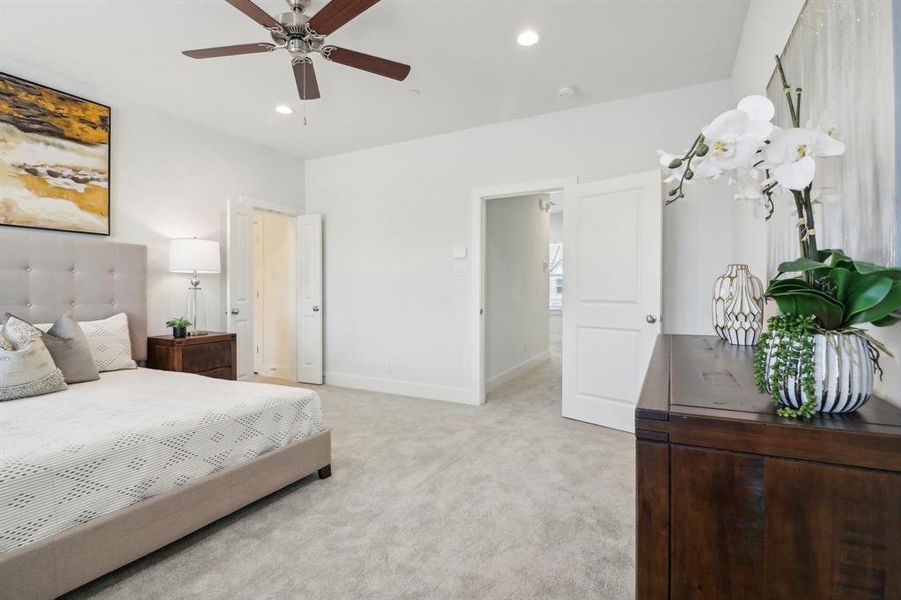 Bedroom featuring light carpet and ceiling fan