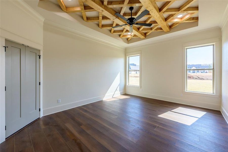 Unfurnished room with coffered ceiling, ceiling fan, dark wood-type flooring, and ornamental molding