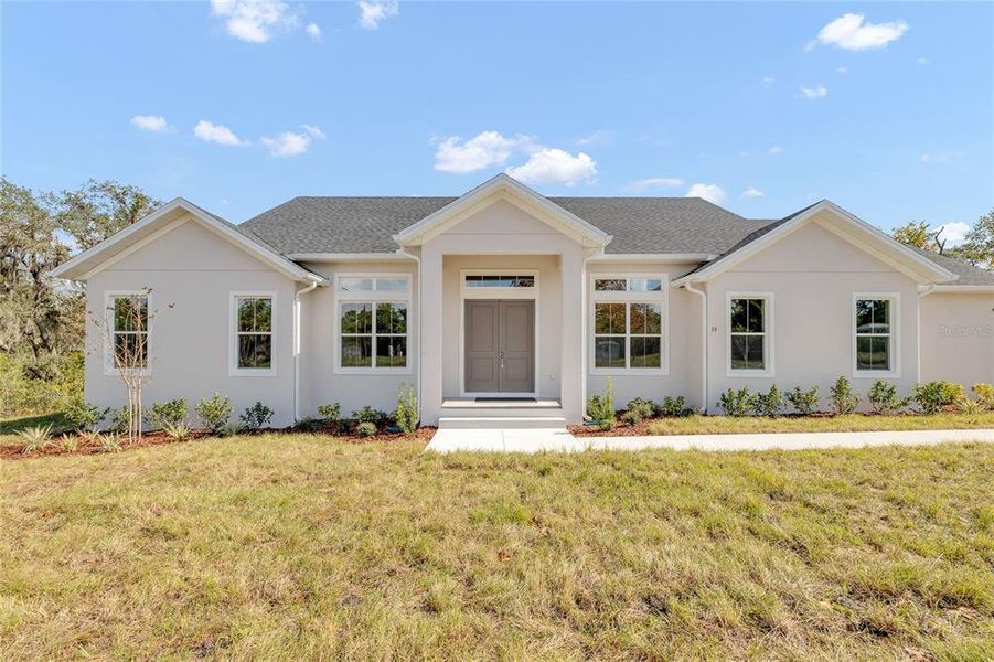 Front exterior of a new home in , Debary, FL, highlighting curb appeal (Image 1). Front exterior of a new home in , Debary, FL, highlighting curb appeal (Image 1).