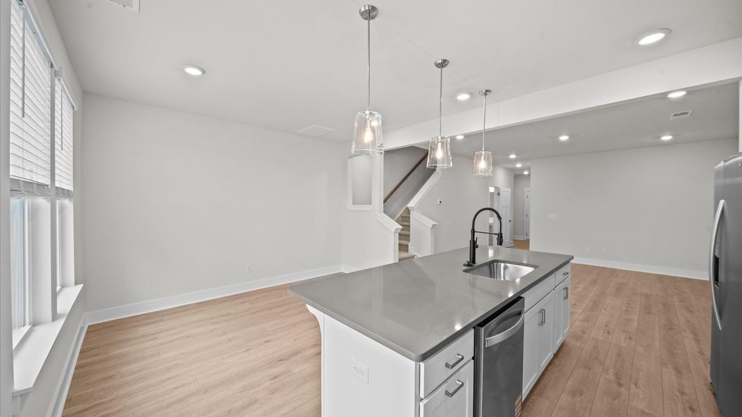 First-class kitchen with a spacious 9-foot island—perfect for entertaining beneath designer pendant lighting First-class kitchen with a spacious 9-foot island—perfect for entertaining beneath designer pendant lighting