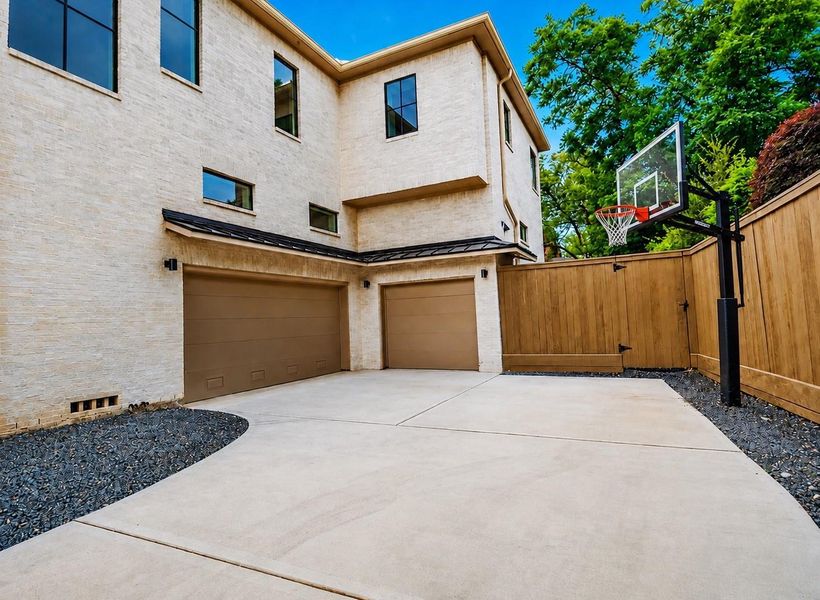 The private motor court offers exceptional convenience with a oversized three-car garage, abundant guest parking, and secure gated access for added privacy and peace of mind. Beyond the iron gate, this area could be the perfect dedicated play area