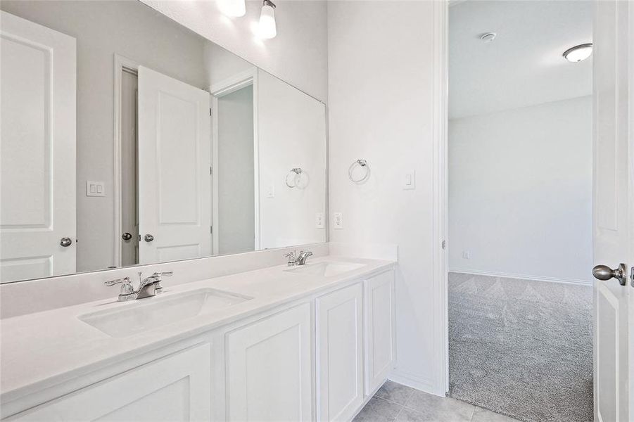 Bathroom with tile patterned flooring and vanity