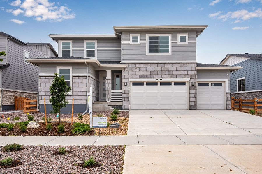 Front exterior of a new home in The Aurora Highlands, Aurora, CO, highlighting curb appeal (Image 1). Front exterior of a new home in The Aurora Highlands, Aurora, CO, highlighting curb appeal (Image 1).