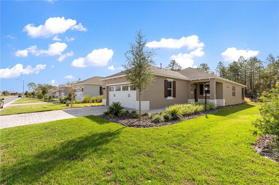 Front exterior of a new home in On Top of the World Communities, Ocala, FL, highlighting curb appeal (Image 26).