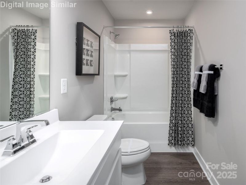 Relax and refresh — the guest bath features dual sinks, plenty of counter space, and a tub perfect for unwinding after a long day. Relax and refresh — the guest bath features dual sinks, plenty of counter space, and a tub perfect for unwinding after a long day.