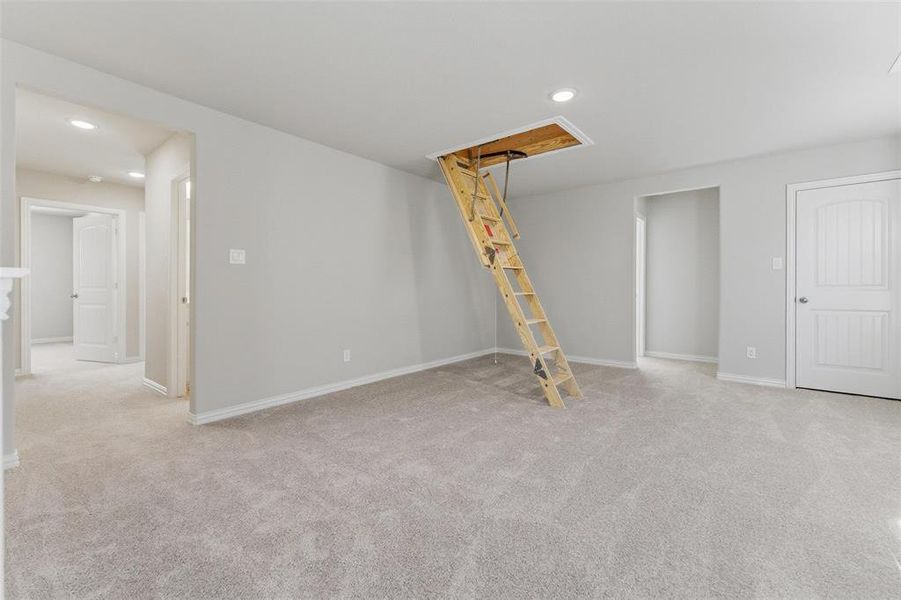 Basement with light carpet and recessed lighting