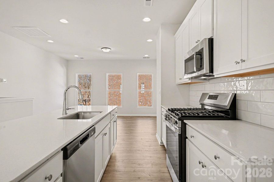 Kitchen with Gas Range, Tile Backsplash, Quartz Countertops