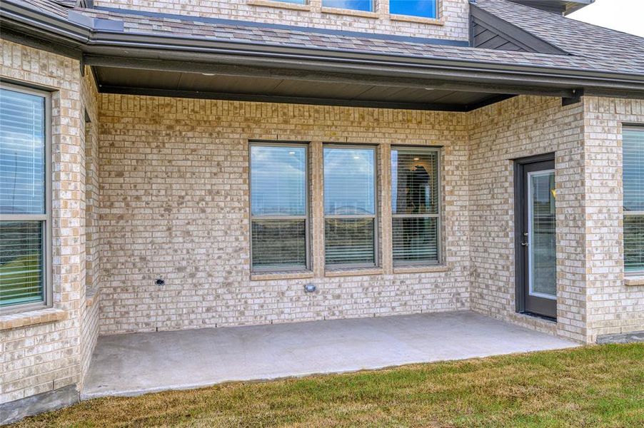 Front exterior of a new home in Pioneer Estates, Blue Ridge, TX, highlighting curb appeal (Image 21).