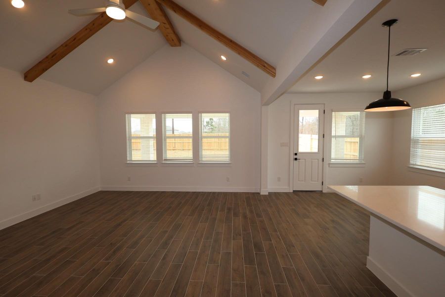 Bright and airy great room with vaulted ceilings and stained beams Bright and airy great room with vaulted ceilings and stained beams