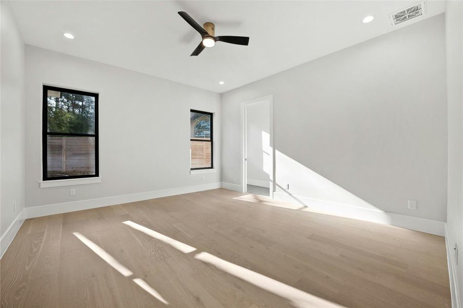Spare room with ceiling fan and light wood-type flooring