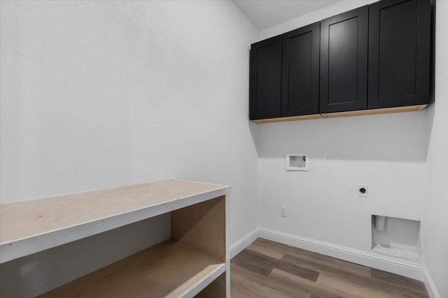Ample overhead cabinetry and a sturdy workbench define this dedicated workspace. Ample overhead cabinetry and a sturdy workbench define this dedicated workspace.