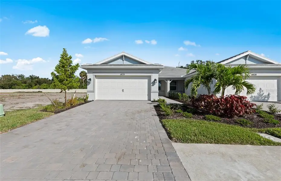 Front exterior of a new home in Legacy Groves, Nokomis, FL, highlighting curb appeal (Image 1). Front exterior of a new home in Legacy Groves, Nokomis, FL, highlighting curb appeal (Image 1).