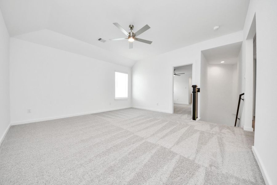 Come upstairs and enjoy a day of leisure in this fabulous game room! This is the perfect hangout spot or adult game room! Features plush carpet, high ceilings, custom paint and windows for plenty of natural light. Sample photo of completed home with similar floor plan. Actual colors and selections may vary.