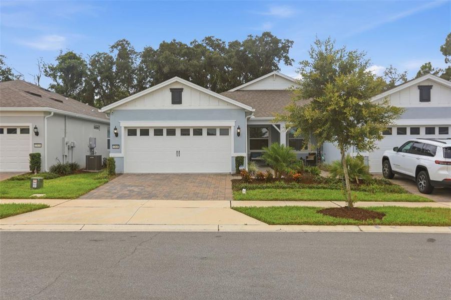 Front exterior of a new home in Del Webb Oasis, Winter Garden, FL, highlighting curb appeal (Image 23). Front exterior of a new home in Del Webb Oasis, Winter Garden, FL, highlighting curb appeal (Image 23).