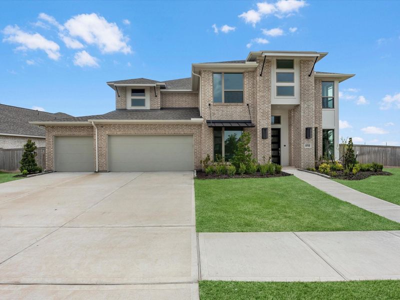 Front exterior of a new home in Valencia, Manvel, TX, highlighting curb appeal (Image 2).