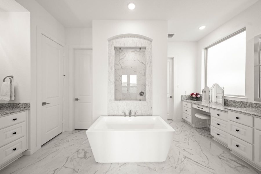 The luxurious primary bath features 12” x 24” tile floor while the freestanding tub and shower are flanked by separate sink sinks and dressing areas.