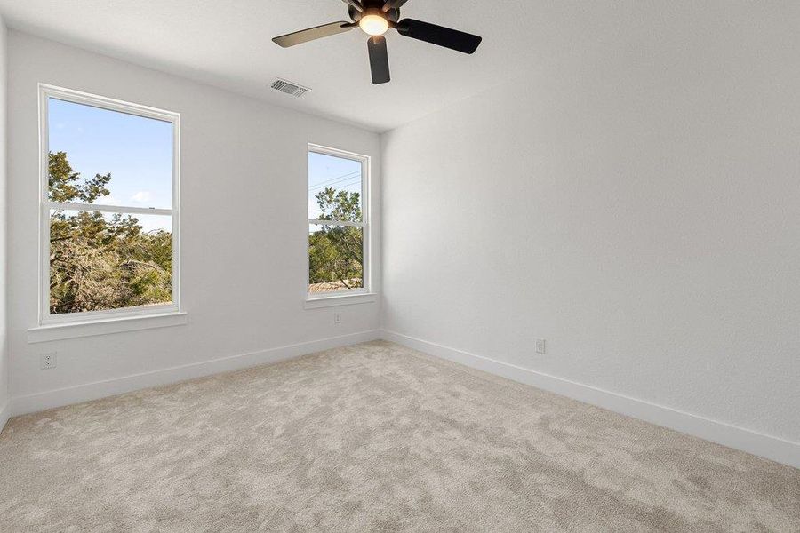 Spare room featuring carpet flooring and ceiling fan