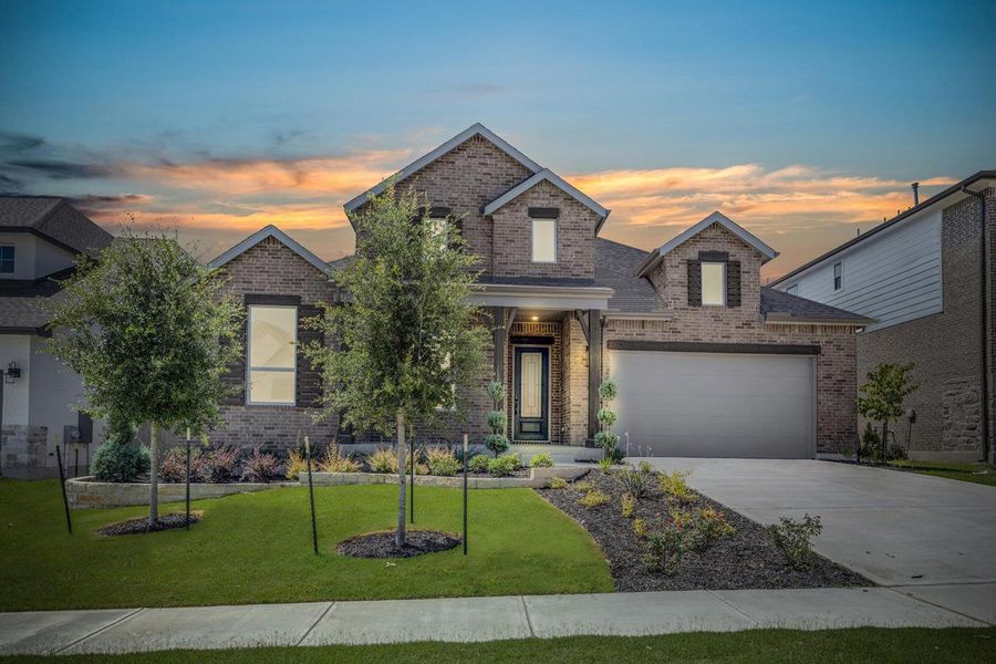 Front exterior of a new home in Flora, Hutto, TX, highlighting curb appeal (Image 2).