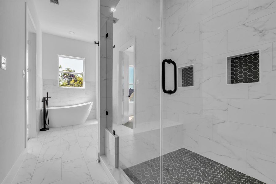 Relax and unwind in this stunningprimary bath, complete with aglass-enclosed shower, a luxuriousbathtub, and double sinks foradded convenience. Relax and unwind in this stunningprimary bath, complete with aglass-enclosed shower, a luxuriousbathtub, and double sinks foradded convenience.