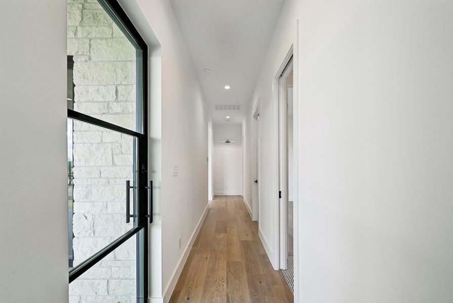 Hall way from Den; exterior door on left to patio. Hall way from Den; exterior door on left to patio.