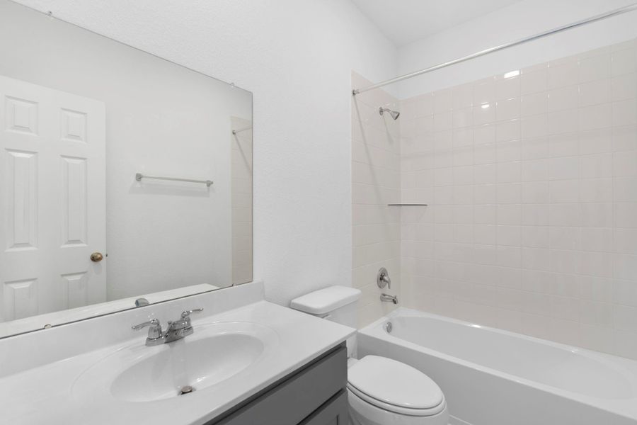 The secondary bath features tile flooring, white cabinetry and light countertops and a shower/tub combo. Perfect for accommodating any visiting family and friends. The secondary bath features tile flooring, white cabinetry and light countertops and a shower/tub combo. Perfect for accommodating any visiting family and friends.