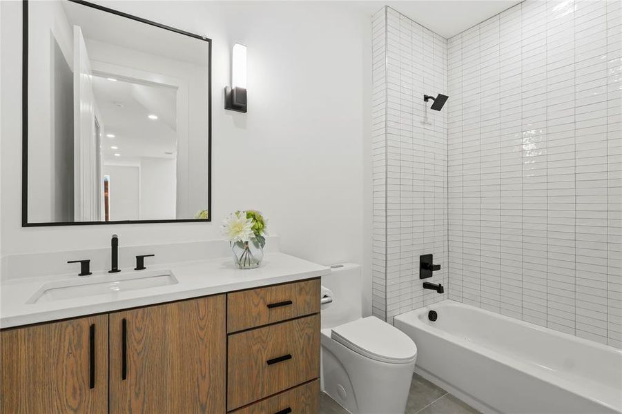 Full bath featuring bathtub / shower combination, vanity, and light tile patterned flooring