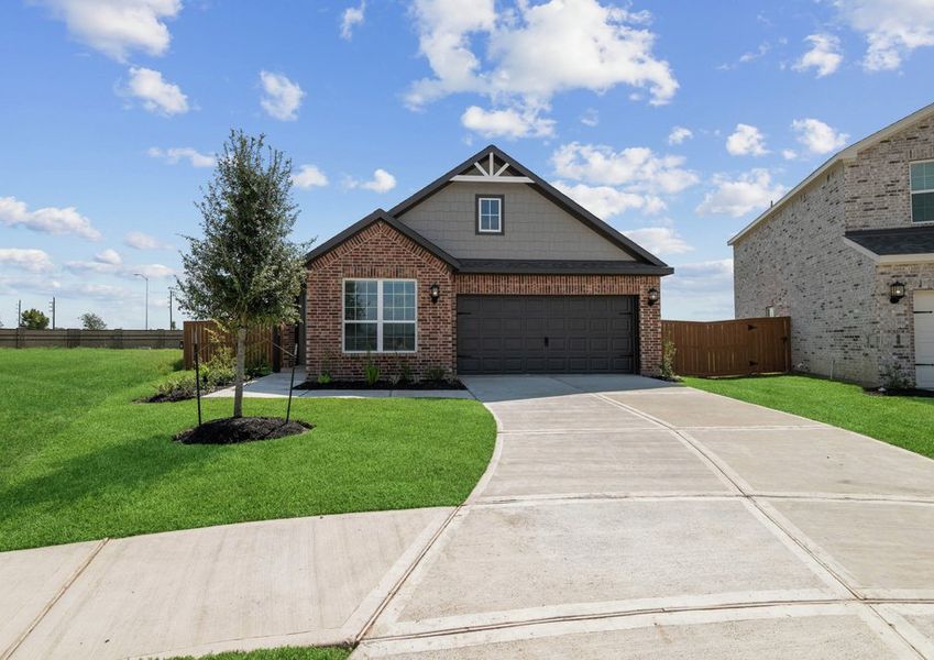 Exterior photo of the two-car garage Victoria plan with brick