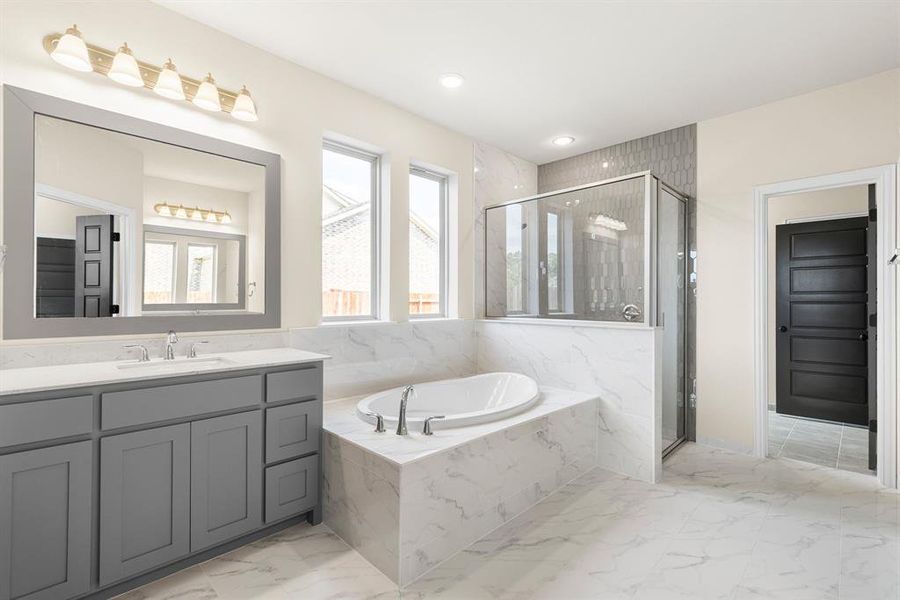 Bathroom featuring independent shower and bath, tile patterned floors, and vanity