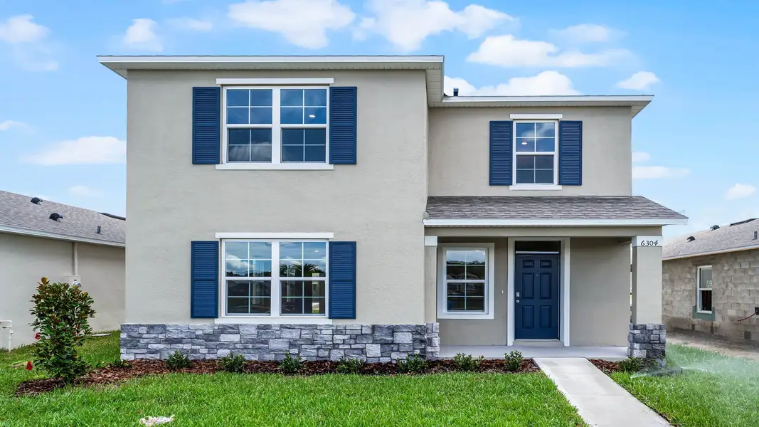 Front exterior of a new home in Crossroads at Kelly Park, Apopka, FL, highlighting curb appeal (Image 1). Front exterior of a new home in Crossroads at Kelly Park, Apopka, FL, highlighting curb appeal (Image 1).