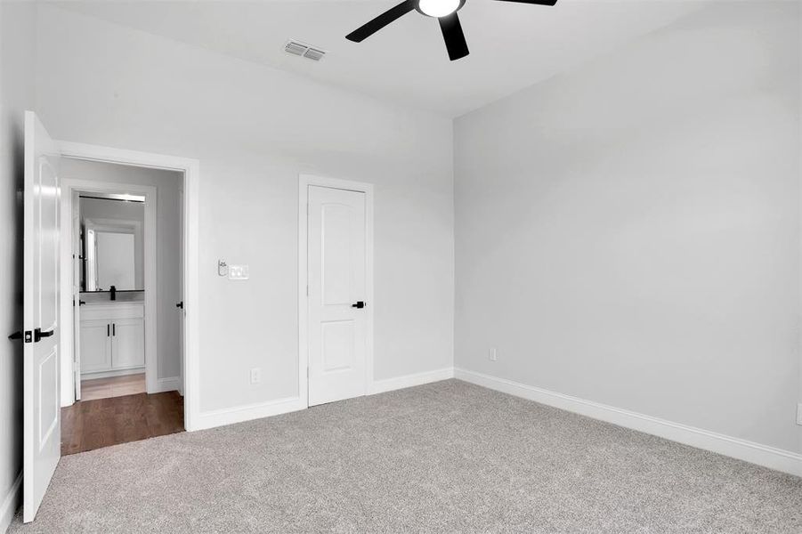 Unfurnished bedroom with carpet floors, ceiling fan, and a closet