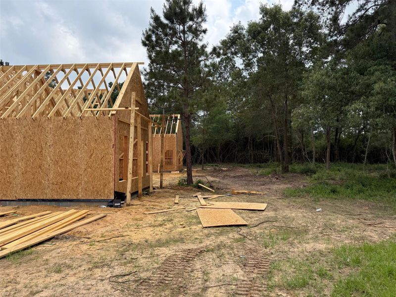 New construction featuring exposed wood framing and oriented strand board sheathing