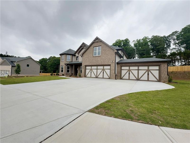 Front exterior of a new home in , Hoschton, GA, highlighting curb appeal (Image 23).