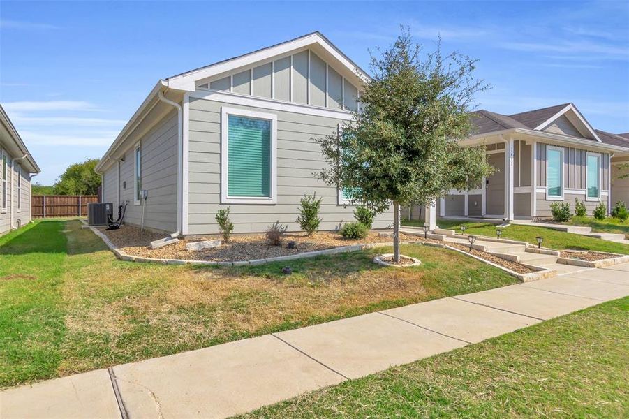View of front of house featuring board and batten siding, a front yard, and a porch