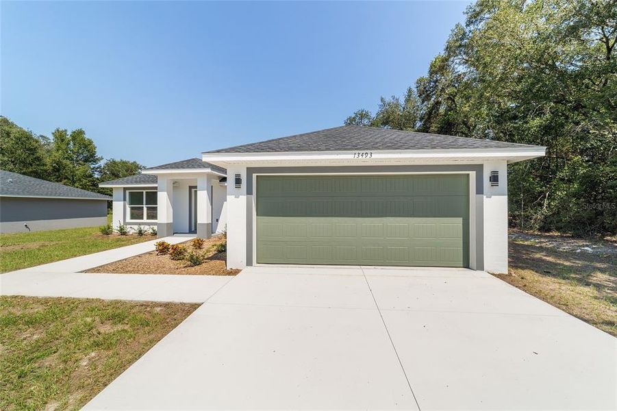 Front exterior of a new home in , Dunnellon, FL, highlighting curb appeal (Image 14).