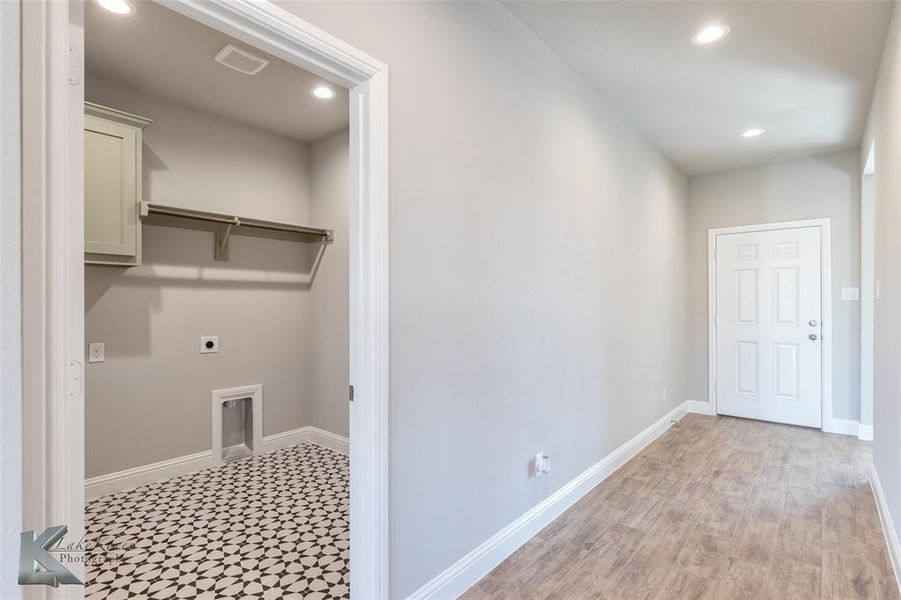 Laundry room featuring recessed lighting, hookup for an electric dryer, and cabinet space